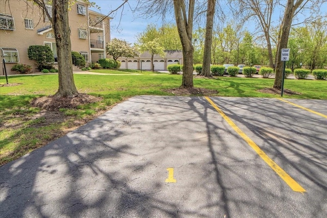 463 Valley Dr Unit 303, Naperville, IL 60563 - view of community featuring uncovered parking and a yard