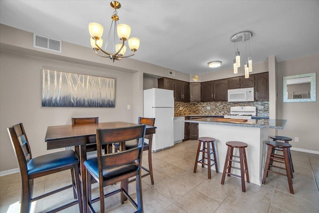 463 Valley Dr Unit 303, Naperville, IL 60563 - kitchen with white appliances, dark brown cabinets, decorative backsplash, a chandelier, and a breakfast bar