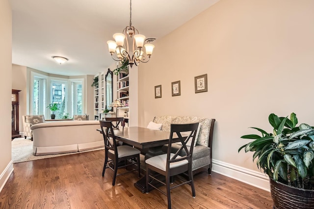 2153 N Sedgwick St, Chicago, IL 60614 - dining area with wood finished floors, baseboards, and a chandelier