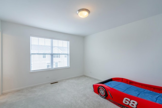 unfurnished bedroom with carpet flooring and baseboards