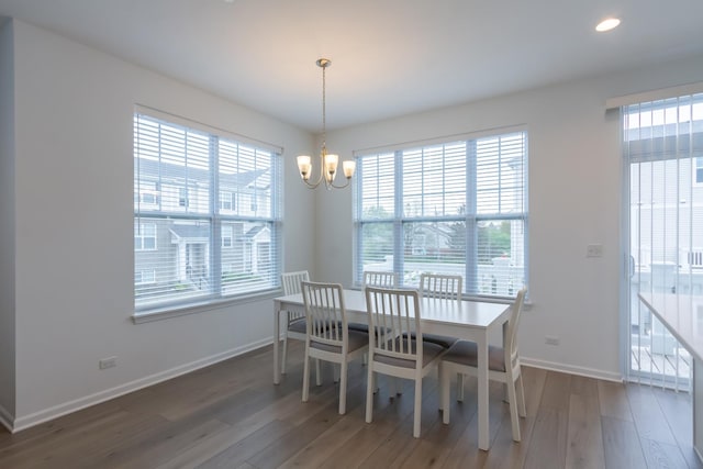 dining room with a chandelier, wood finished floors, baseboards, and recessed lighting