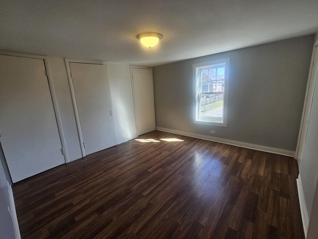 442 Hickory Pl, Elgin, IL 60120 - unfurnished bedroom with dark wood-style floors and baseboards