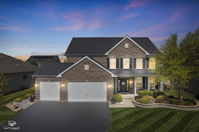 16436 S Mueller Cir, Plainfield, IL 60586 - traditional home featuring brick siding, asphalt driveway, a lawn, and a garage