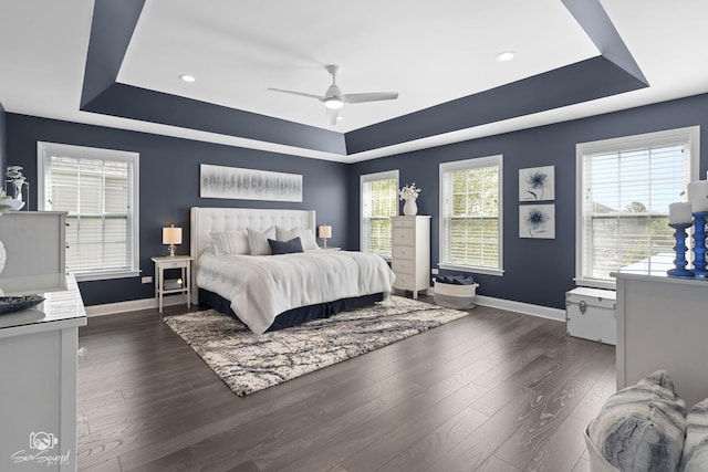 16436 S Mueller Cir, Plainfield, IL 60586 - bedroom featuring a tray ceiling, baseboards, dark wood-style flooring, recessed lighting, and a ceiling fan