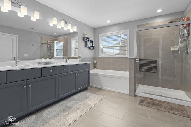 16436 S Mueller Cir, Plainfield, IL 60586 - full bath with a stall shower, tile patterned floors, double vanity, a garden tub, and recessed lighting