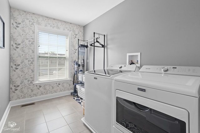 16436 S Mueller Cir, Plainfield, IL 60586 - washroom featuring baseboards, wallpapered walls, washer and clothes dryer, and light tile patterned flooring