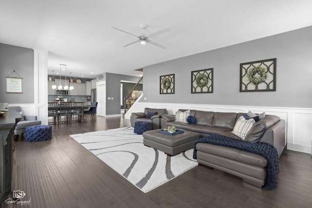 16436 S Mueller Cir, Plainfield, IL 60586 - living area featuring a decorative wall, stairway, wainscoting, ceiling fan, and dark wood finished floors