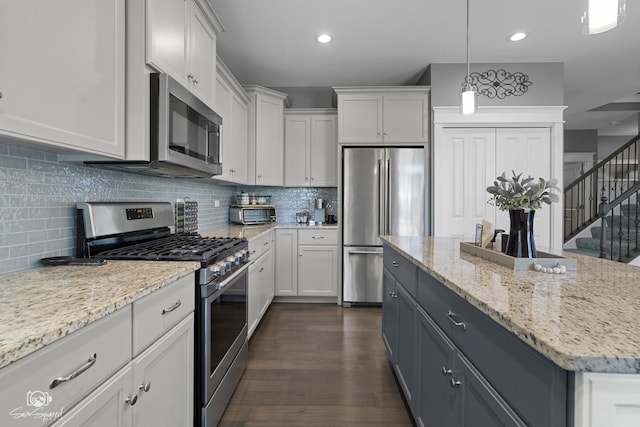 16436 S Mueller Cir, Plainfield, IL 60586 - kitchen with stainless steel appliances, white cabinets, a center island, dark wood-style flooring, and recessed lighting