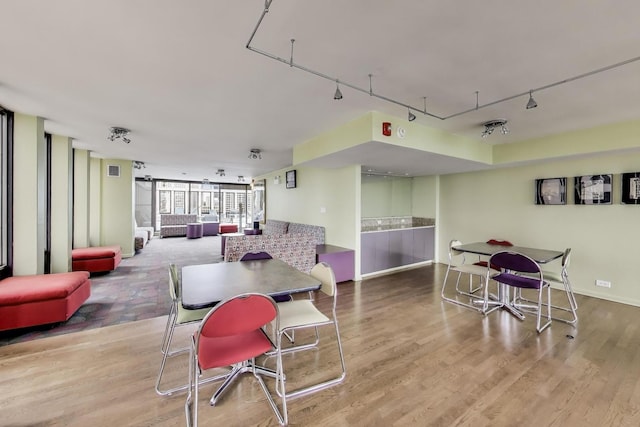 100 E Walton St Unit 25F, Chicago, IL 60611 - dining area featuring track lighting, wood finished floors, and baseboards