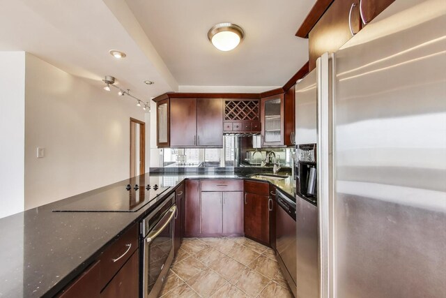 100 E Walton St Unit 25F, Chicago, IL 60611 - kitchen with stainless steel appliances, a sink, dark stone counters, decorative backsplash, and glass insert cabinets