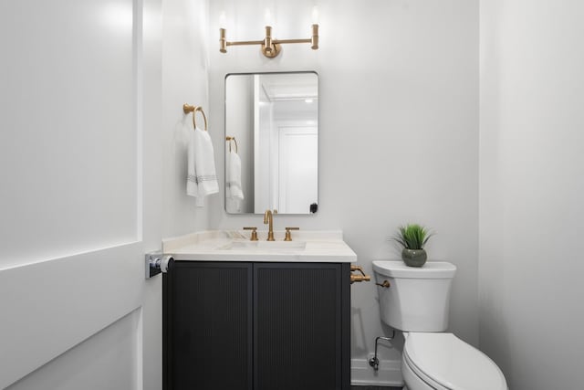 bathroom featuring toilet and vanity
