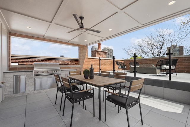 view of patio / terrace featuring area for grilling, an outdoor kitchen, a ceiling fan, a fenced backyard, and outdoor dining area