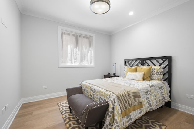 bedroom with wood finished floors, crown molding, baseboards, and recessed lighting
