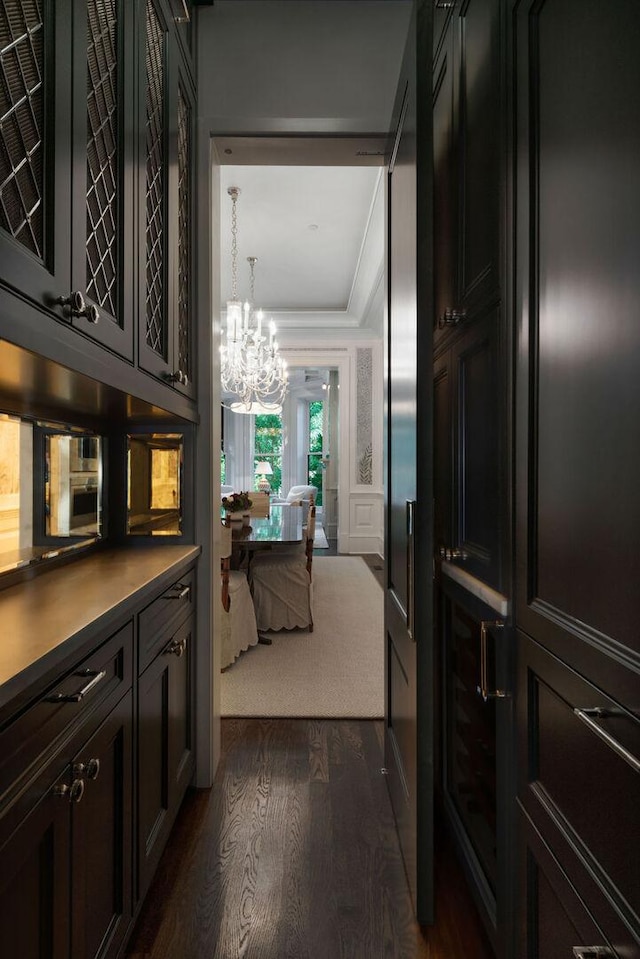 1534 N Dearborn Pkwy, Chicago, IL 60610 - hall with dark wood-type flooring, a chandelier, and ornamental molding