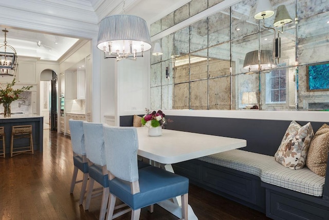 1534 N Dearborn Pkwy, Chicago, IL 60610 - dining area featuring a chandelier, ornamental molding, dark wood-style flooring, and arched walkways