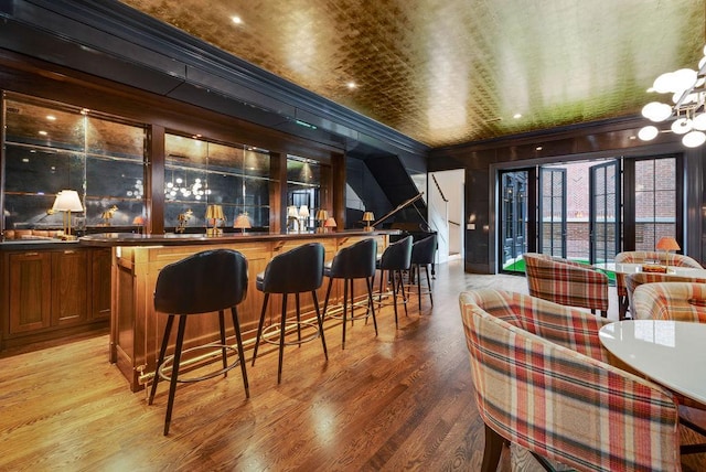1534 N Dearborn Pkwy, Chicago, IL 60610 - indoor bar featuring ornamental molding, wood finished floors, and a chandelier