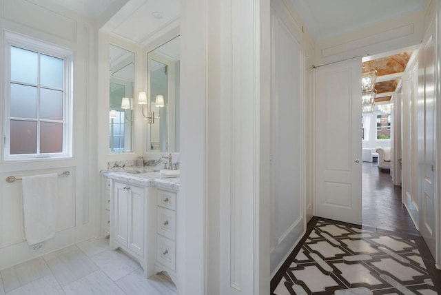 1534 N Dearborn Pkwy, Chicago, IL 60610 - bathroom featuring a chandelier, vanity, and ornamental molding