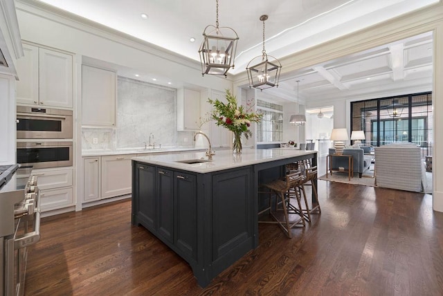 1534 N Dearborn Pkwy, Chicago, IL 60610 - kitchen featuring a sink, a chandelier, light countertops, coffered ceiling, and a kitchen island with sink