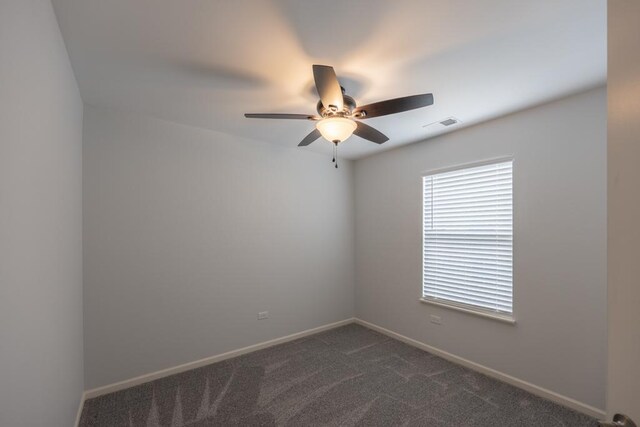 189 Lakeshore Dr, Oswego, IL 60543 - empty room with ceiling fan, dark carpet, and baseboards