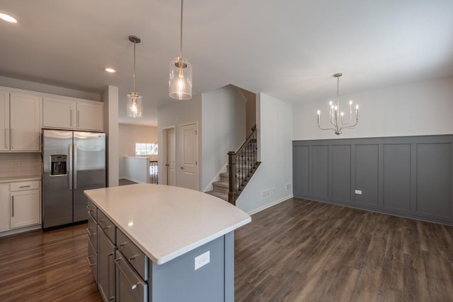 189 Lakeshore Dr, Oswego, IL 60543 - kitchen featuring stainless steel refrigerator with ice dispenser, a chandelier, light countertops, dark wood-style flooring, and pendant lighting