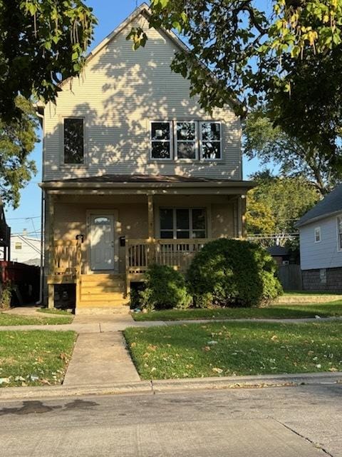 7941 S Woodlawn Ave, Chicago, IL 60619 - view of front of property with covered porch and a front yard