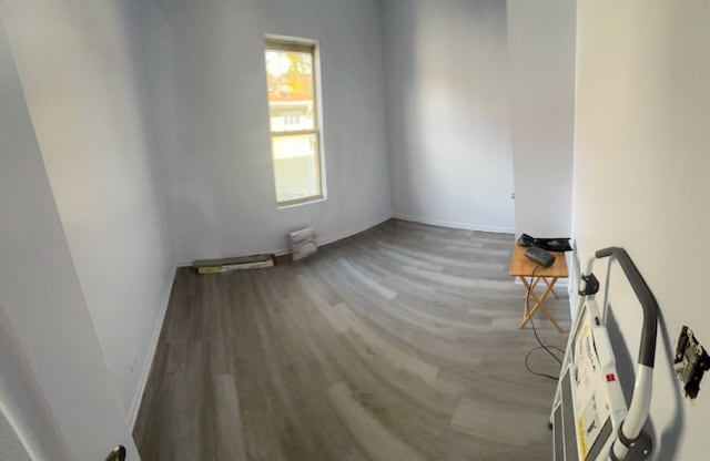 7941 S Woodlawn Ave, Chicago, IL 60619 - unfurnished room featuring wood finished floors and baseboards