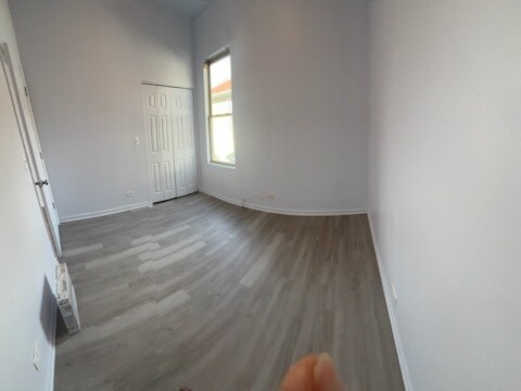 7941 S Woodlawn Ave, Chicago, IL 60619 - empty room with wood finished floors and baseboards