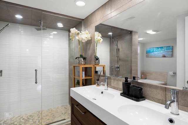 full bath featuring a stall shower, recessed lighting, and double vanity