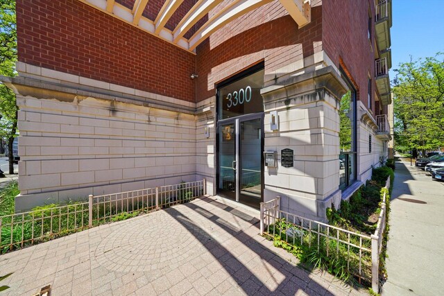 3300 W Irving Park Rd Unit F4, Chicago, IL 60618 - view of exterior entry featuring brick siding