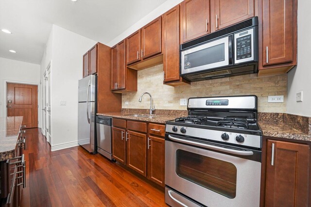 3300 W Irving Park Rd Unit F4, Chicago, IL 60618 - kitchen featuring appliances with stainless steel finishes, dark wood finished floors, tasteful backsplash, recessed lighting, and dark stone counters