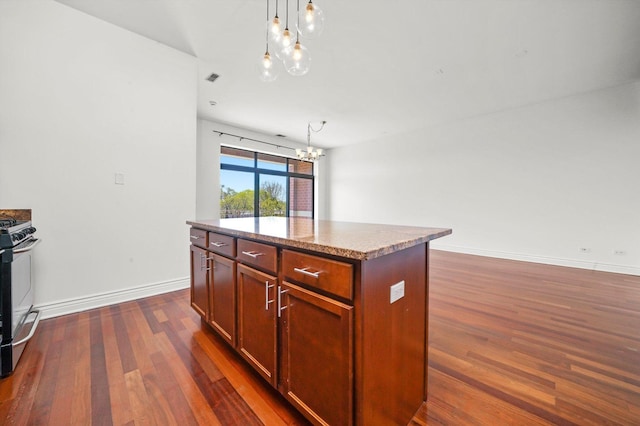 3300 W Irving Park Rd Unit F4, Chicago, IL 60618 - kitchen with a chandelier, dark wood finished floors, gas stove, a kitchen island, and decorative light fixtures