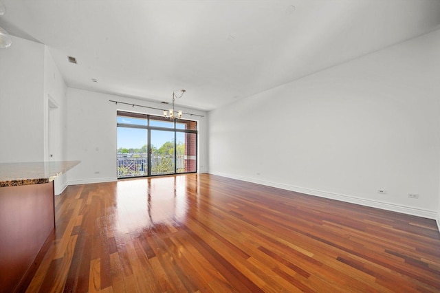 3300 W Irving Park Rd Unit F4, Chicago, IL 60618 - unfurnished living room with a chandelier and wood finished floors
