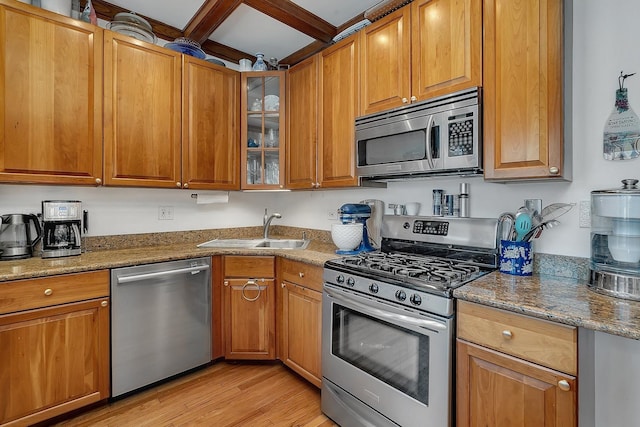 2540 N Sacramento Ave Unit 1, Chicago, IL 60647 - kitchen with appliances with stainless steel finishes, light wood-type flooring, stone countertops, and brown cabinetry