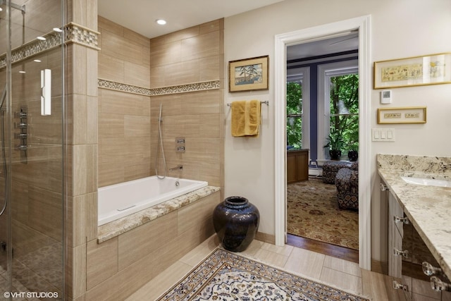 bathroom with tiled shower, vanity, tiled bath, and recessed lighting