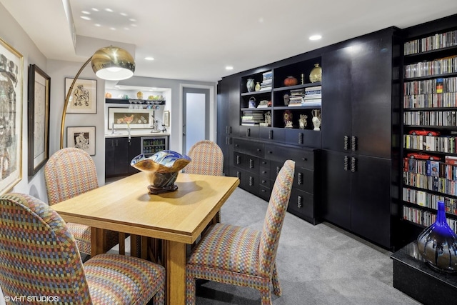 carpeted dining space featuring a bar, wine cooler, and recessed lighting