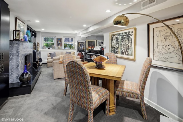 carpeted dining space featuring recessed lighting, a fireplace, and baseboards