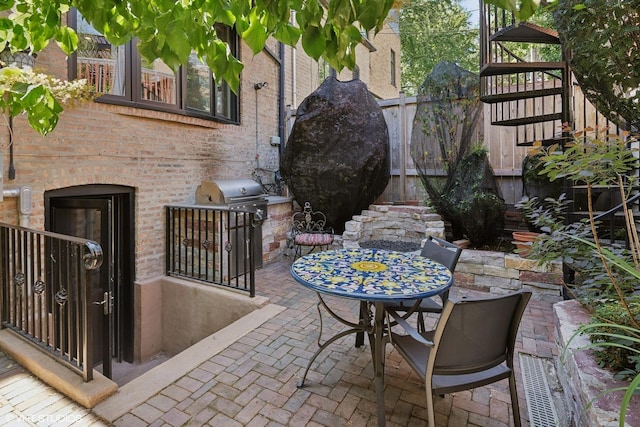 view of patio / terrace featuring stairway and a grill