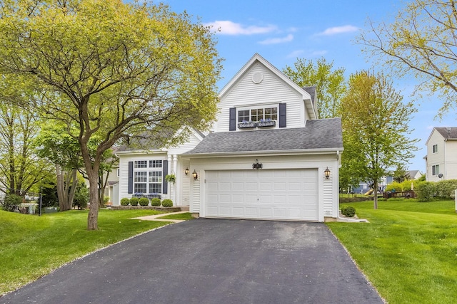 traditional-style house with asphalt driveway, a front yard, an attached garage, and roof with shingles
