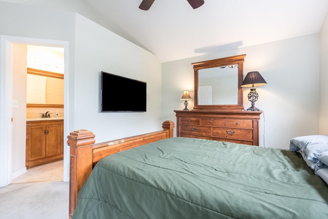 bedroom featuring vaulted ceiling, a sink, light carpet, a ceiling fan, and light tile patterned floors