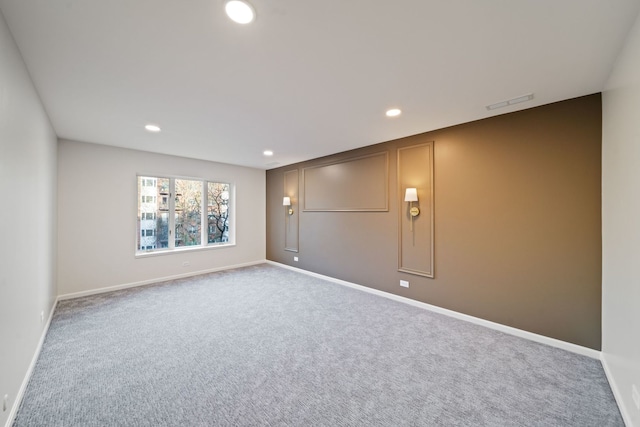empty room featuring recessed lighting, carpet floors, and baseboards