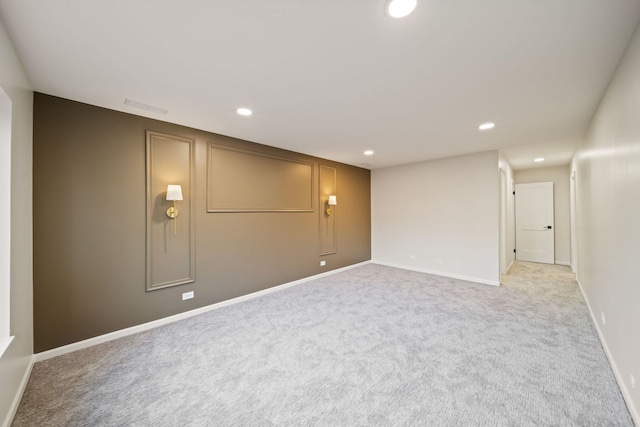 basement with recessed lighting, light carpet, and baseboards