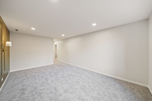 carpeted spare room featuring recessed lighting and baseboards