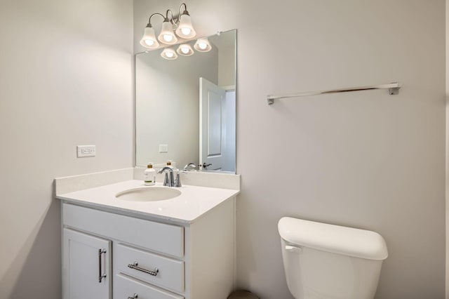 half bathroom with vanity and toilet