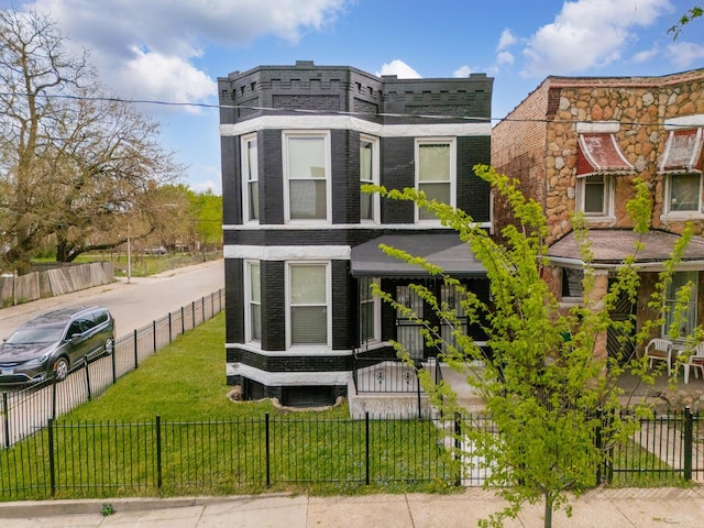 view of front of property with a fenced front yard and brick siding
