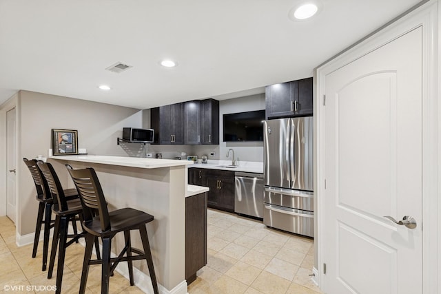 20662 Francisca Way, Frankfort, IL 60423 - kitchen with appliances with stainless steel finishes, a sink, a breakfast bar area, light countertops, and a peninsula