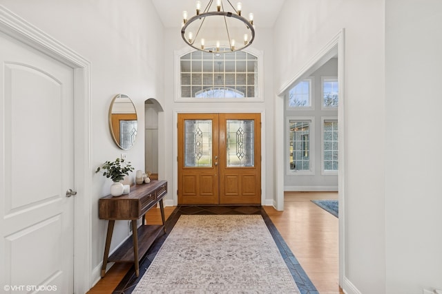 20662 Francisca Way, Frankfort, IL 60423 - foyer entrance featuring a chandelier, dark wood-style floors, baseboards, a high ceiling, and arched walkways