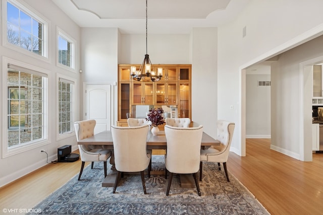 20662 Francisca Way, Frankfort, IL 60423 - dining room featuring a high ceiling, wood finished floors, a chandelier, and baseboards