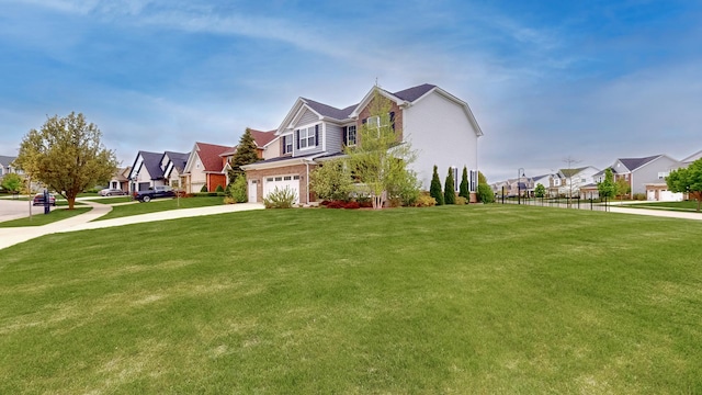 view of side of property with a residential view, a garage, a yard, and driveway