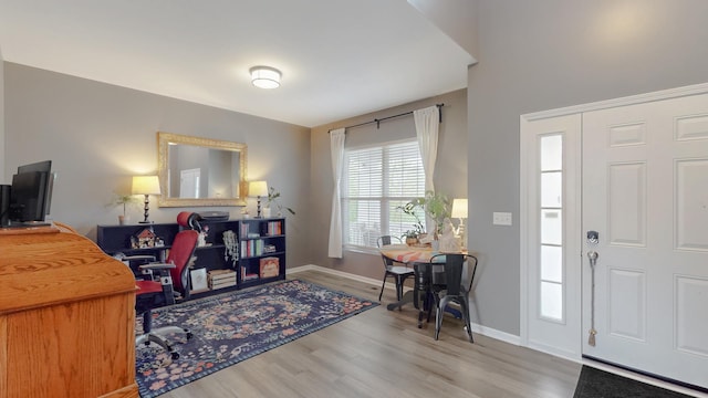 foyer with wood finished floors and baseboards