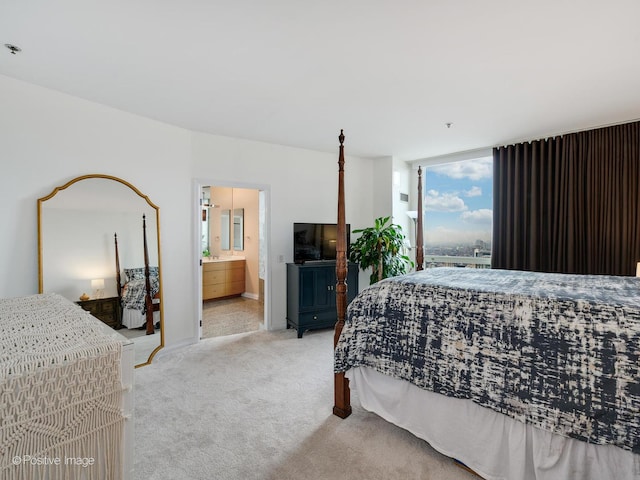 33 W Ontario St Unit 58E, Chicago, IL 60654 - bedroom with light colored carpet, connected bathroom, and baseboards